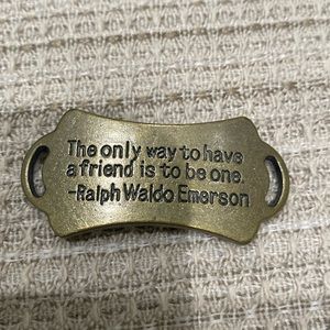 Gold bracelet charm with a quote from ralph waldi emerson